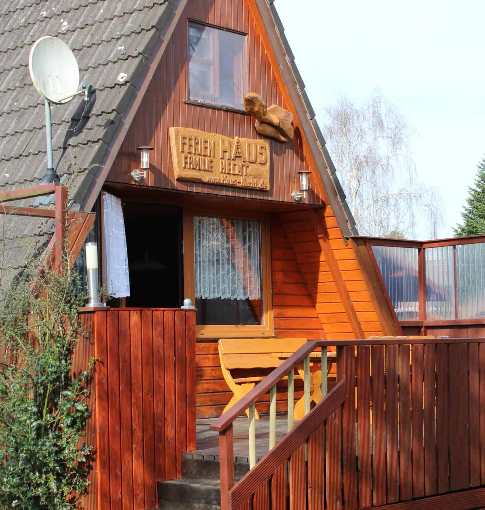 Ferienhaus mit Holzfassade und Balkon in der Natur.